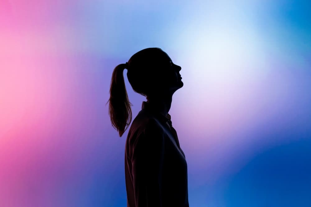 Silhouette portrait lit by colorful gradient light